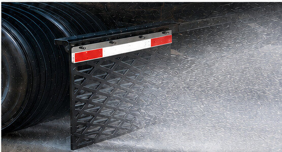 Streamline mud flap in service, controlling road spray behind a trailer wheel